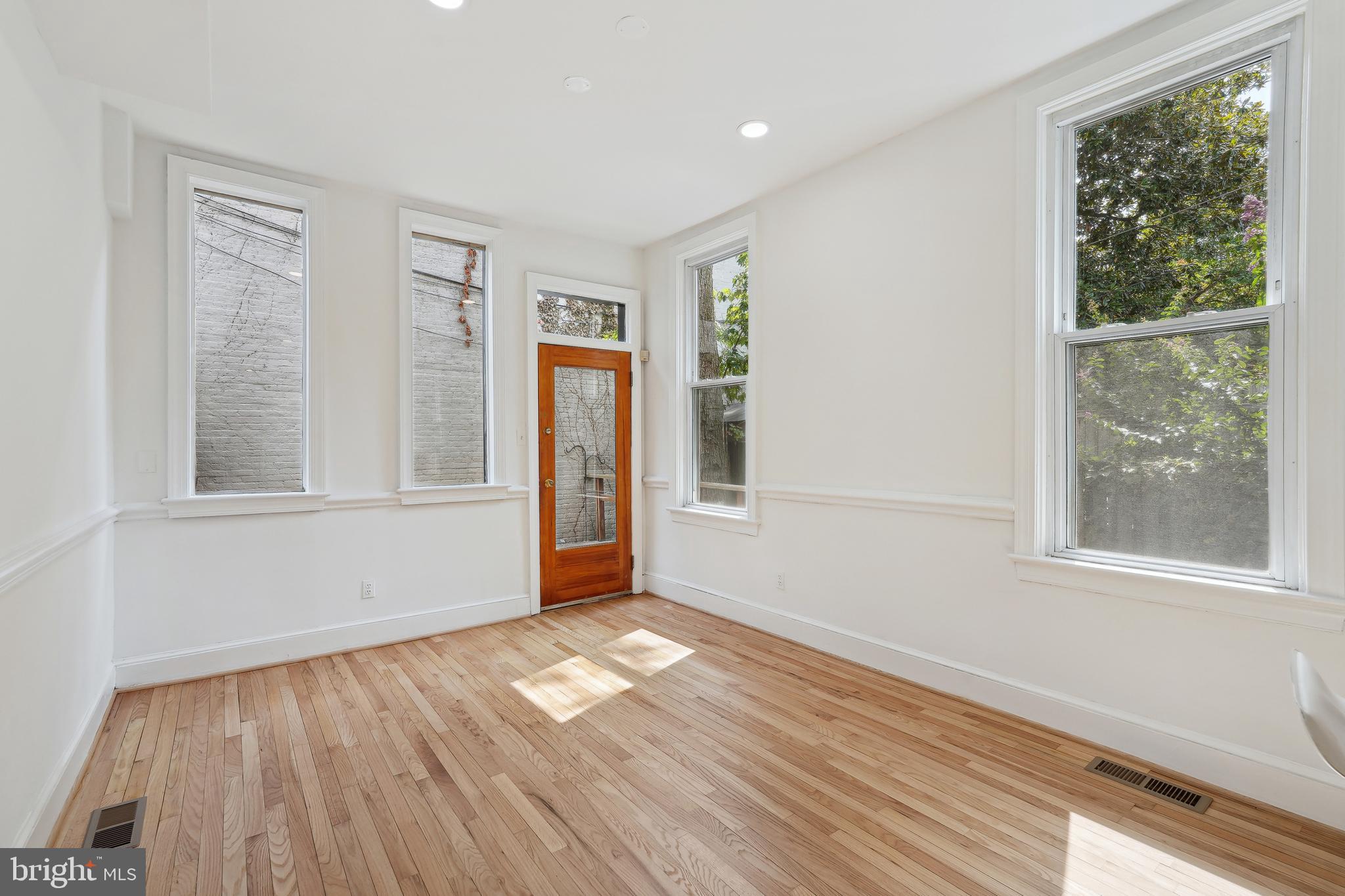 329 Constitution Avenue Northeast Washington, DC 20002 - Photo 25 of 62 a view of empty room with wooden floor and fan