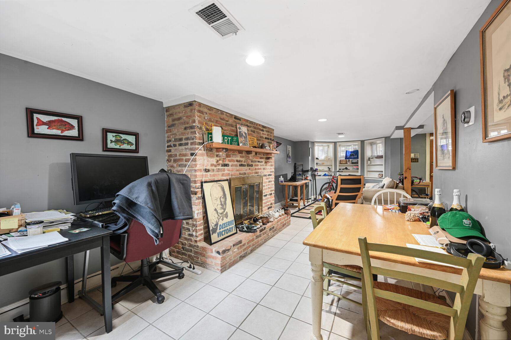 329 Constitution Avenue Northeast Washington, DC 20002 - Photo 42 of 62 a view of a workspace with furniture and a flat screen tv