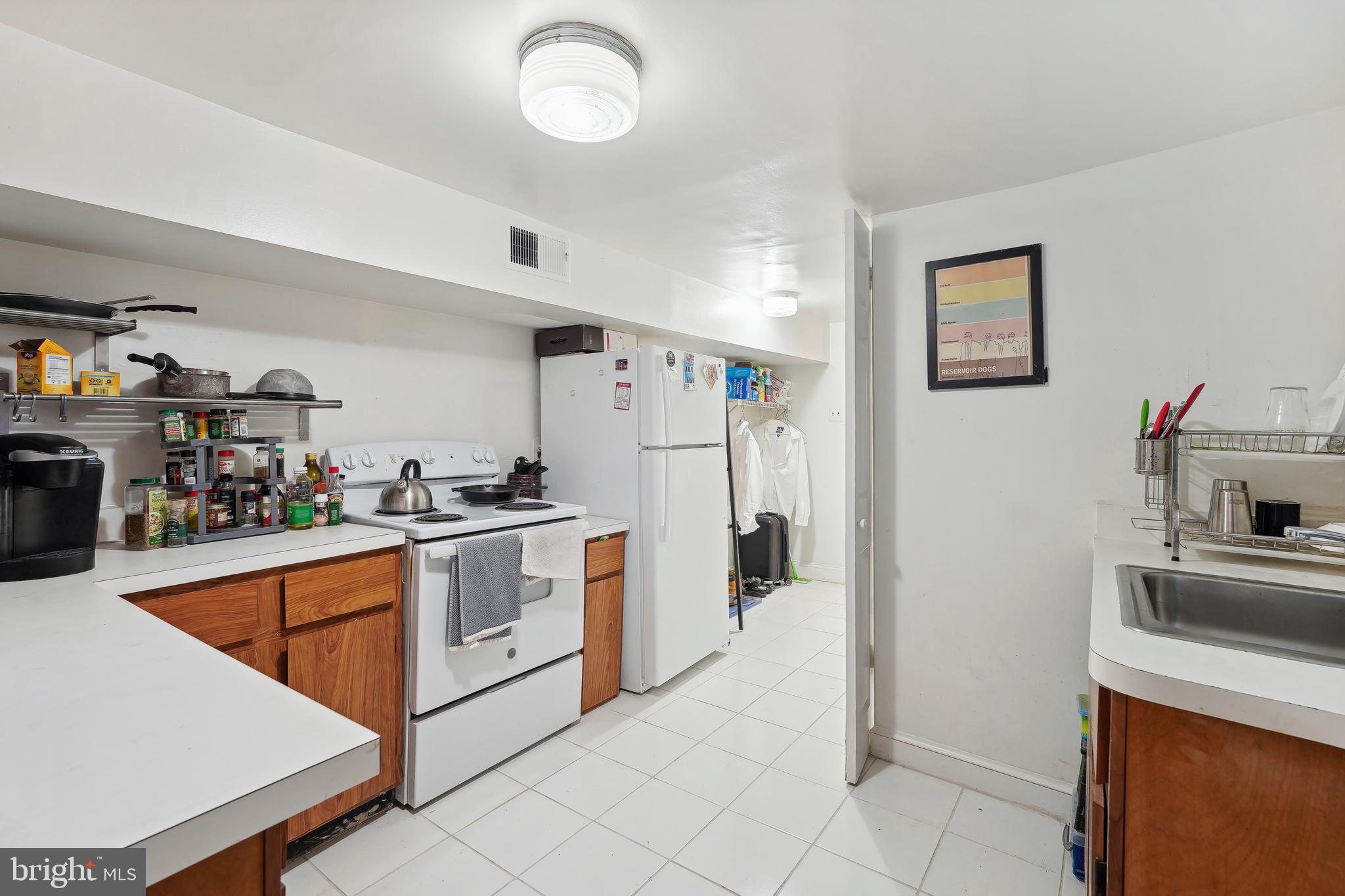 329 Constitution Avenue Northeast Washington, DC 20002 - Photo 51 of 62 a kitchen with white cabinets and white appliances