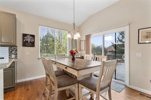 a view of a dining room with furniture large windows and wooden floor