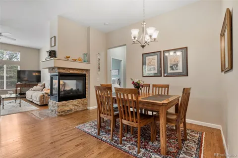 a view of a dining room with furniture wooden floor and a chandelier