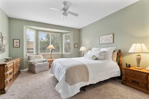 a bedroom with a bed couch and window