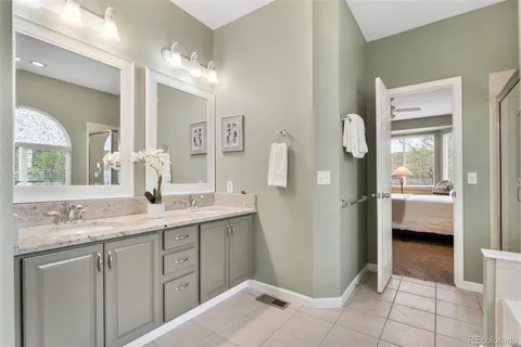 a spacious bathroom with a sink a mirror and a shower