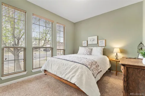 a bed sitting in a bedroom next to a window