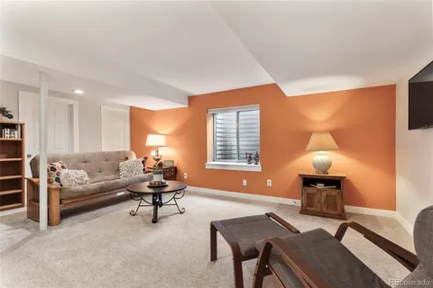 a living room with furniture and a lamp