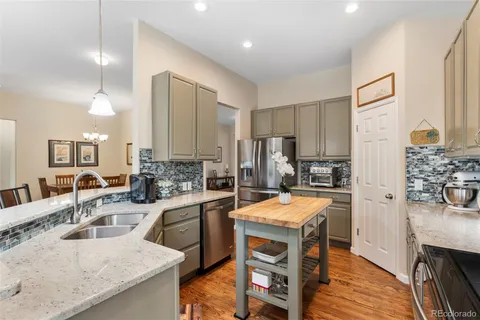 a kitchen with a sink stove and refrigerator