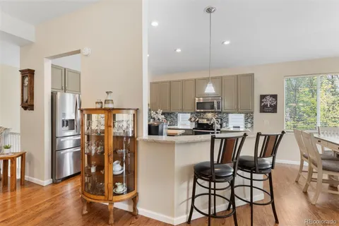 a kitchen with kitchen island wooden cabinets and stainless steel appliances