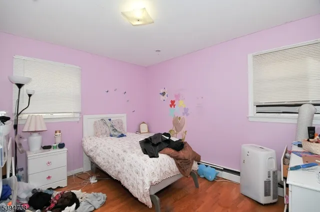a bedroom with pink walls and pink walls