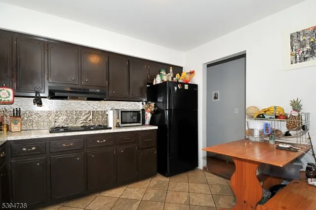 a kitchen with stainless steel appliances granite countertop a sink counter space and cabinets
