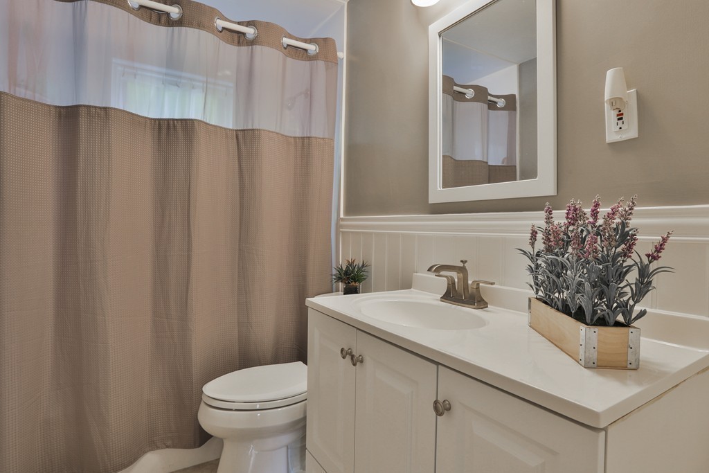 8 Walnut Road Chelmsford, MA 01824 - Photo 17 of 22 a bathroom with a sink toilet and mirror