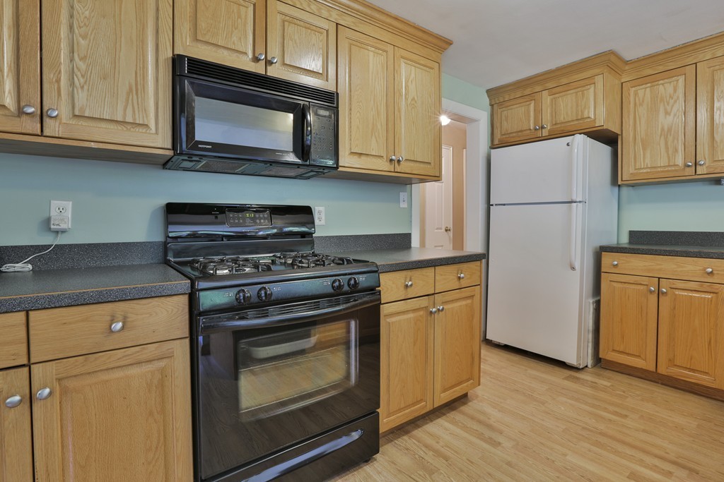8 Walnut Road Chelmsford, MA 01824 - Photo 10 of 22 a kitchen with granite countertop wooden cabinets stainless steel appliances and wooden cabinets