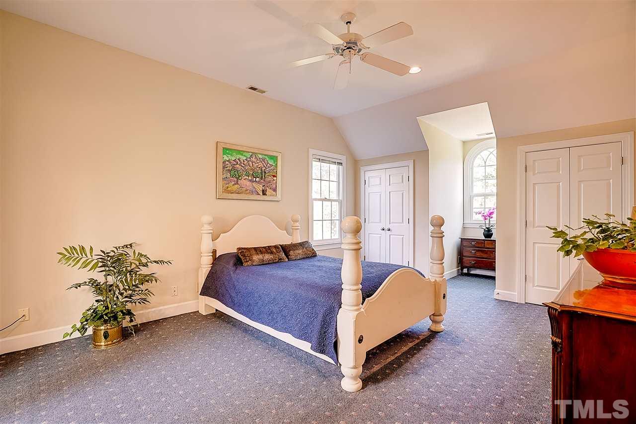 1325 Farmview Road Hillsborough, NC 27278 - Photo 14 of 25 a spacious bedroom with a bed and a chandelier
