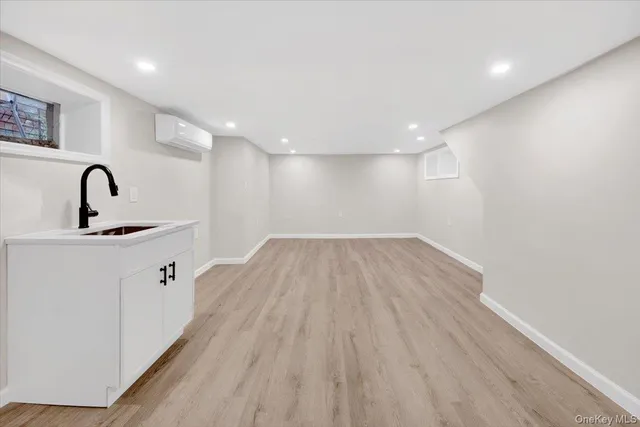 a view of a room with wooden floor and entryway