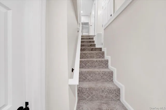 a view of staircase with white walls