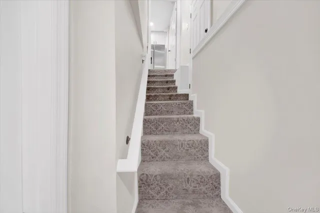 a view of staircase with white walls