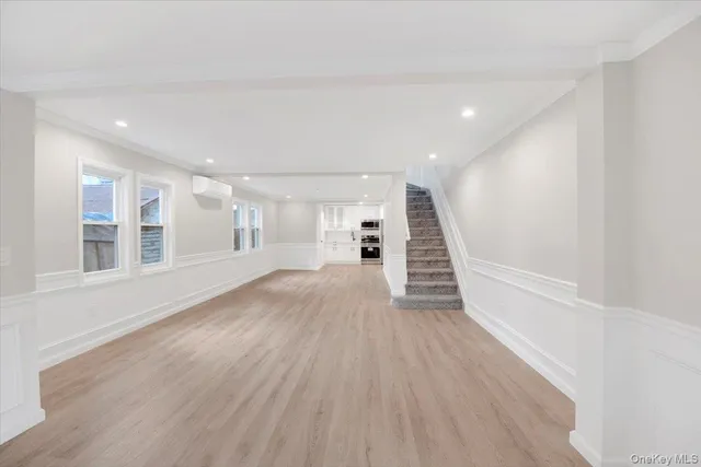 a view of a room with wooden floors and stairs