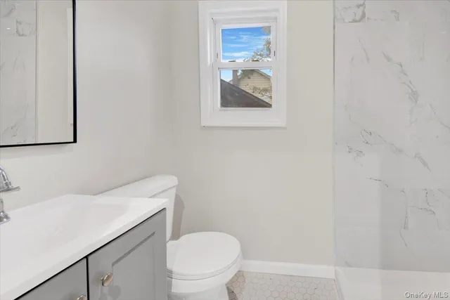 a white toilet sitting next to a bathroom sink