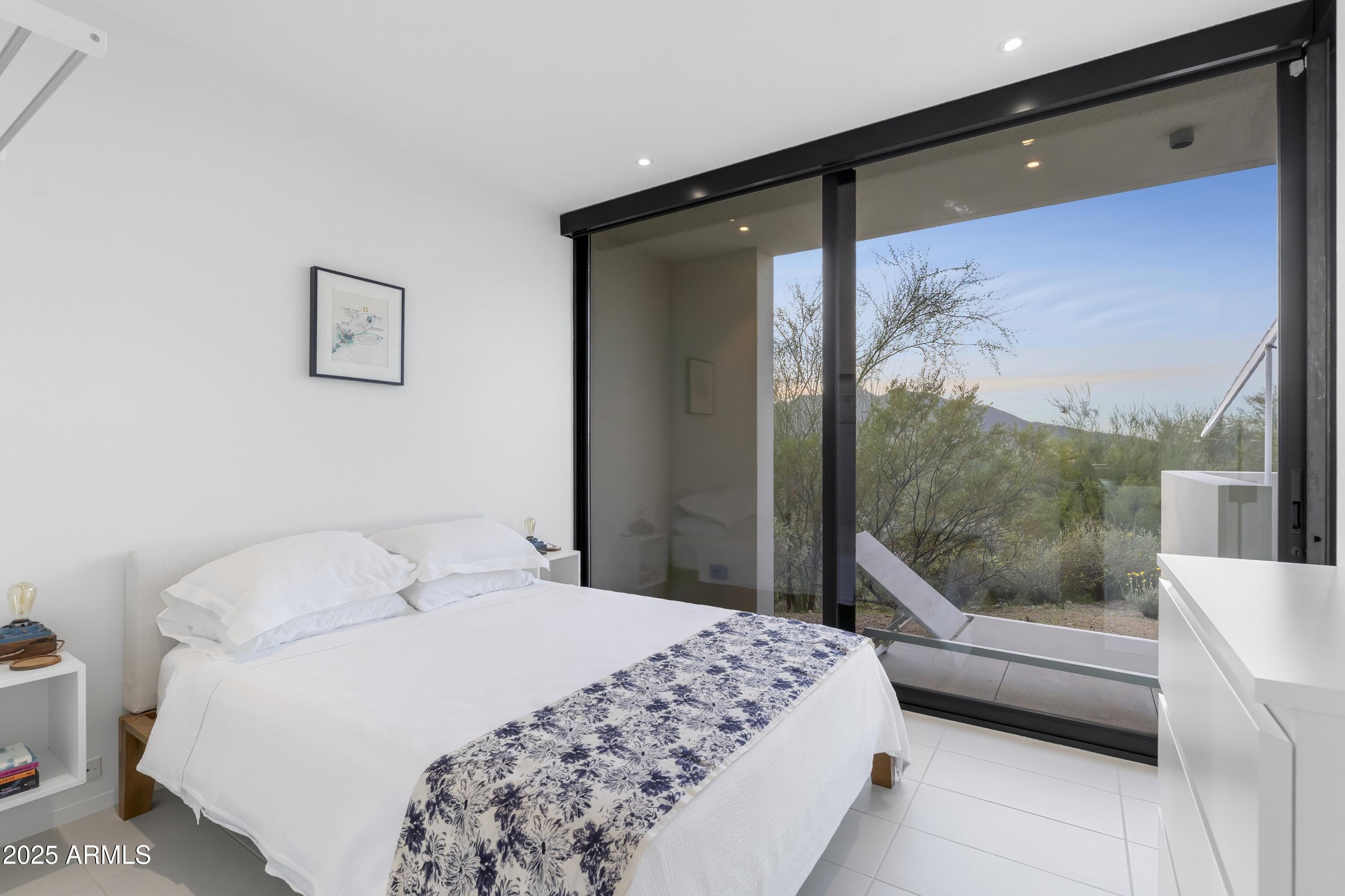 7915 East Primrose Path Carefree, AZ 85377 - Photo 50 of 55 a bedroom with a large bed and a balcony view