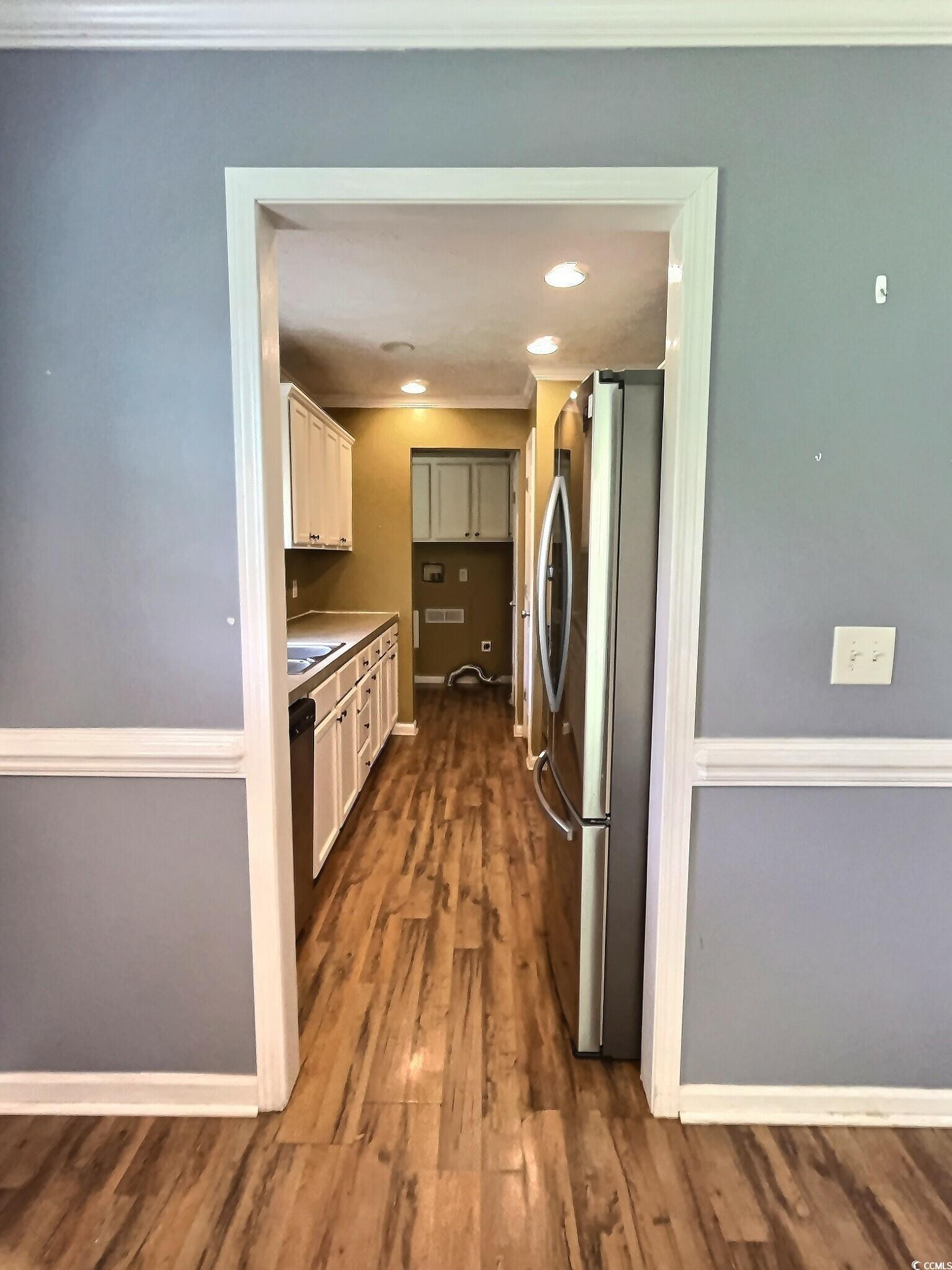 1000 Westgate Place Loris, SC 29569 - Photo 13 of 26 Kitchen with freestanding refrigerator, dark wood-type flooring, ornamental molding, recessed lighting, and white cabinets