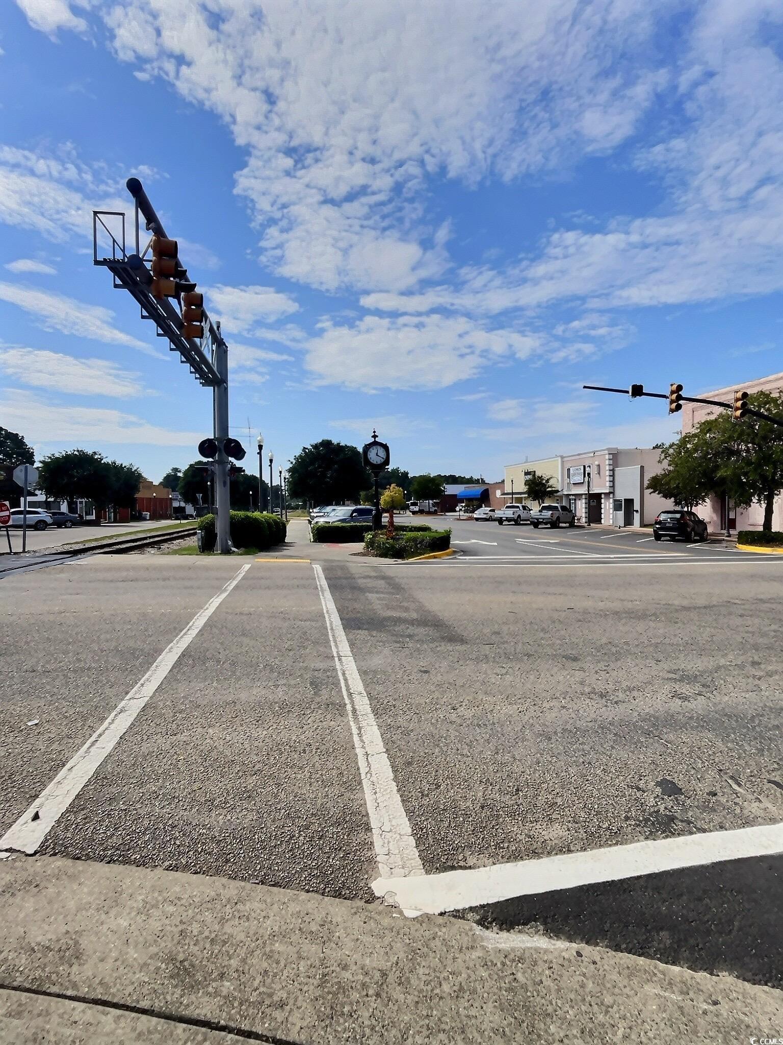 1000 Westgate Place Loris, SC 29569 - Photo 24 of 26 View of asphalt road with traffic lights, curbs, sidewalks, and street lights