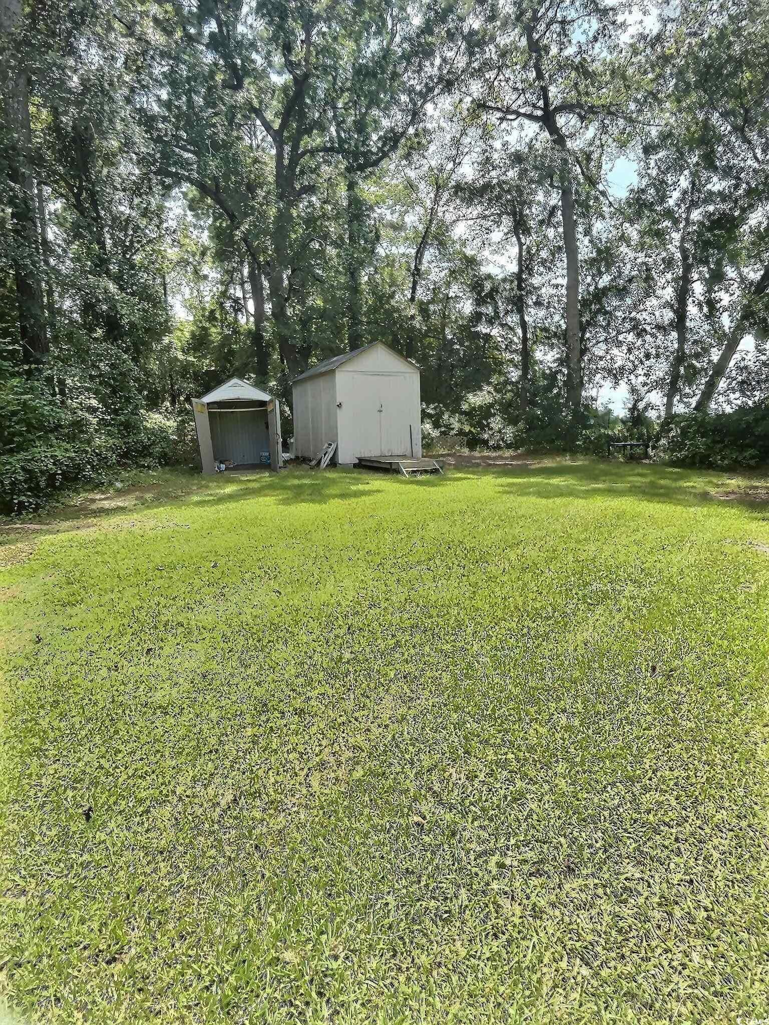 1000 Westgate Place Loris, SC 29569 - Photo 5 of 26 View of green lawn featuring a shed and view of scattered trees