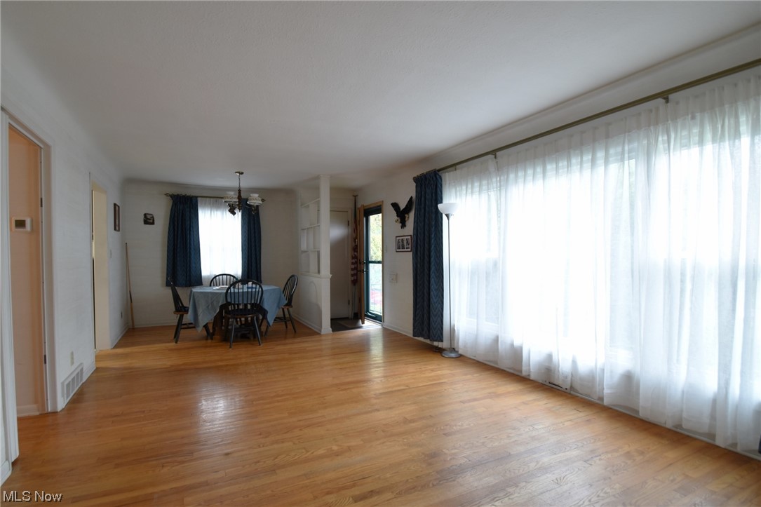 28740 Forest Road Willowick, OH 44095 - Photo 7 of 27 Living room with light hardwood flooring and a chandelier