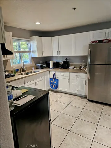 a kitchen with a sink a stove a refrigerator and cabinets