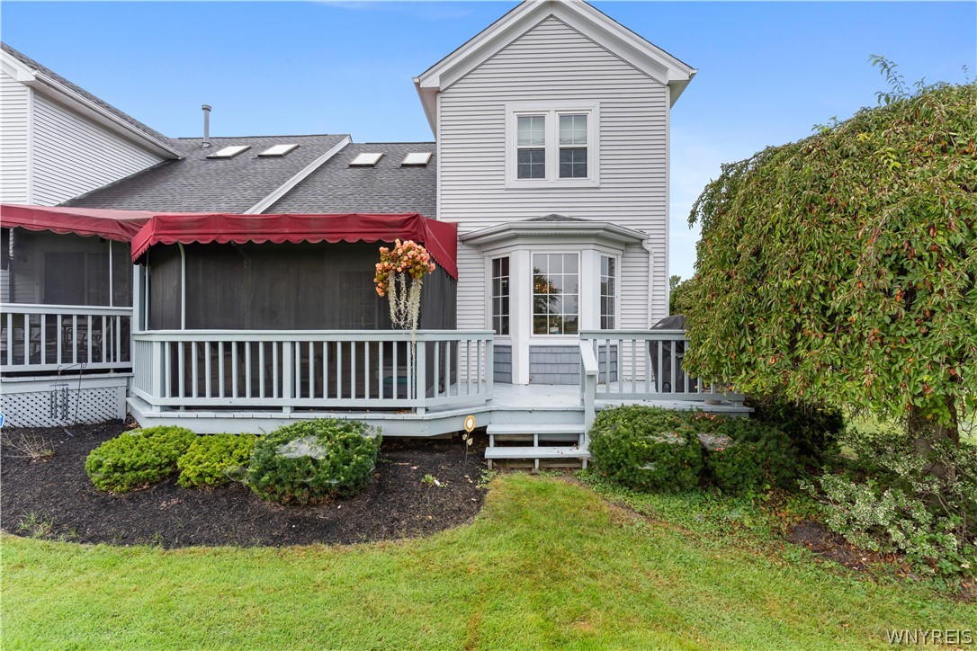 2850 Amsdell Road, Unit 34 Hamburg, NY 14075 - Photo 32 of 33 An elevated wood deck with custom awnings extends from the vinyl-sided rear exterior.