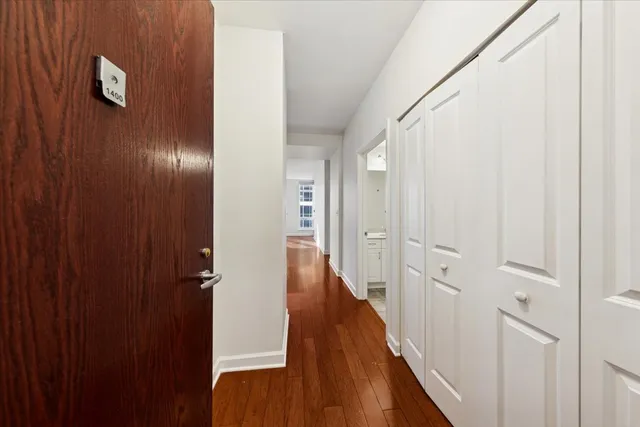 a view of a hallway with wooden floor