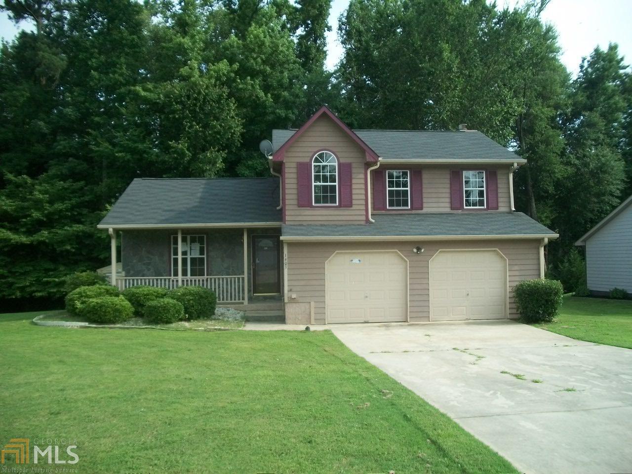 1403 Misty Ridge Court Hampton, GA 30228 - Photo 1 of 1 front view of a house with a yard