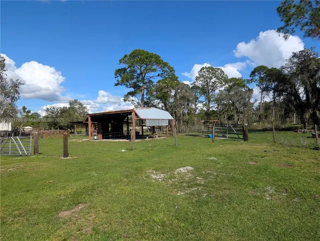 a view of house with backyard and outdoor seating