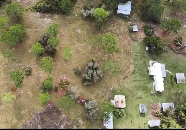 a kitchen with white cabinets stainless steel appliances a sink and a window