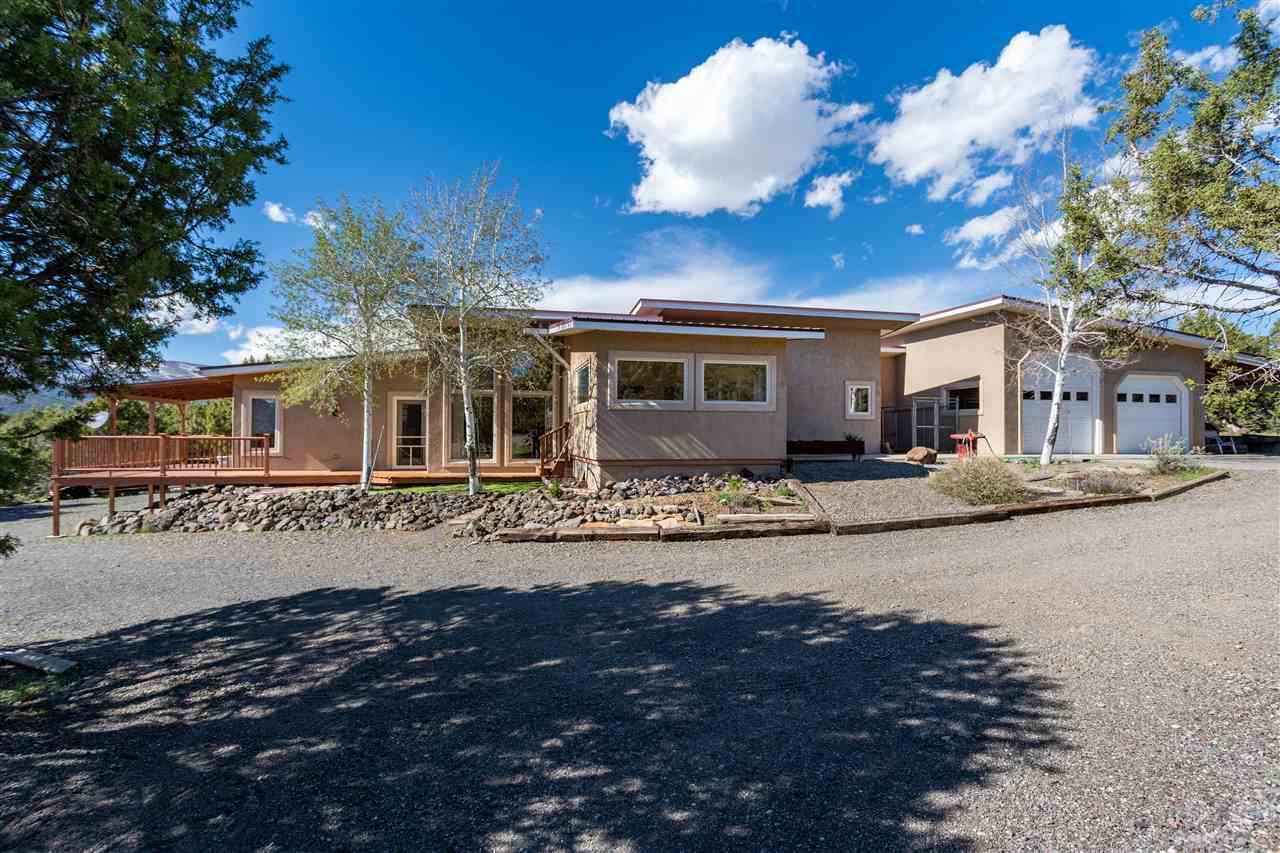 18735 Northridge Road Cedaredge, CO 81413 - Photo 1 of 26 a front view of a house with a yard