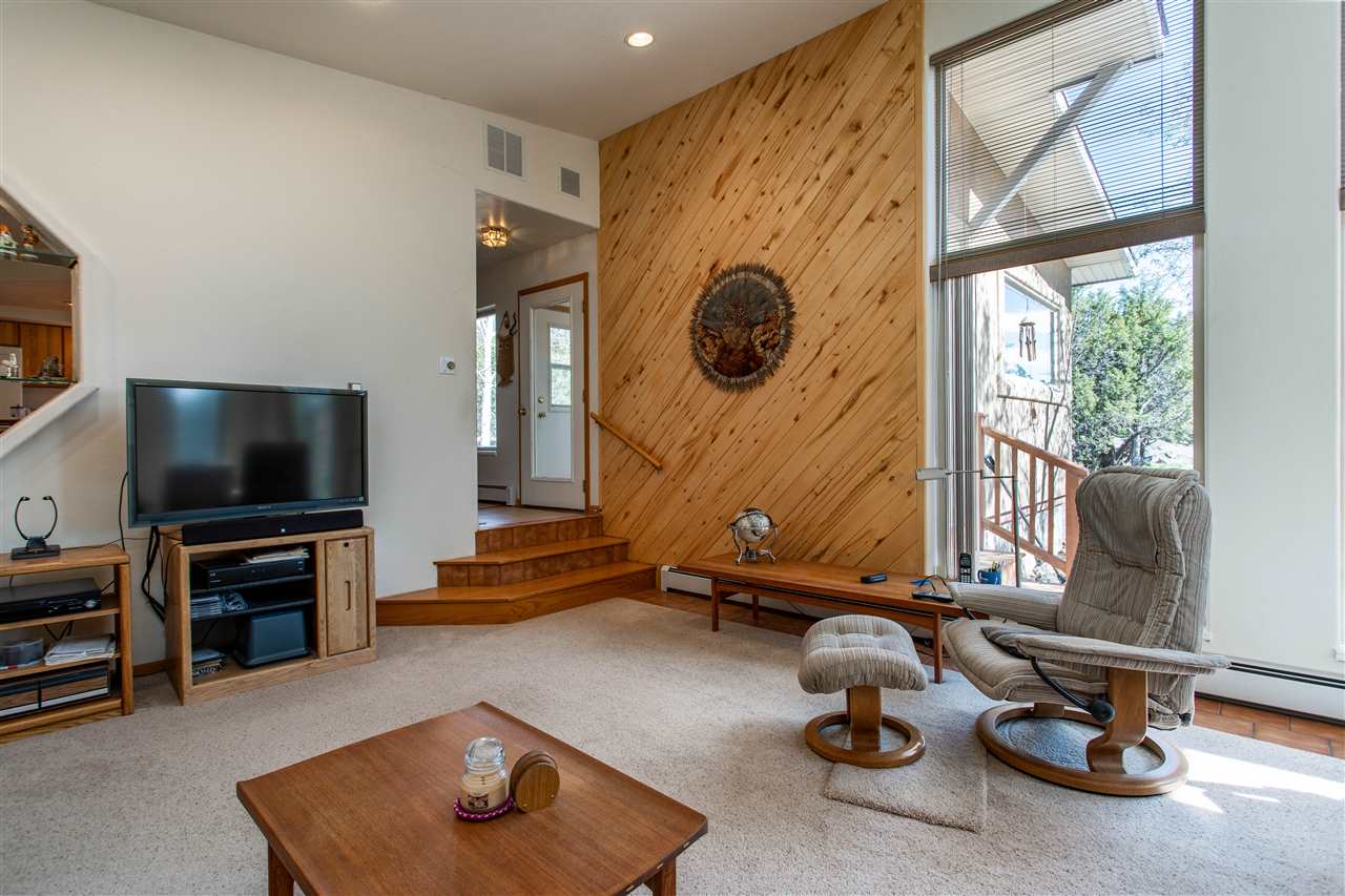 18735 Northridge Road Cedaredge, CO 81413 - Photo 13 of 26 a room with gym equipment and a flat screen tv