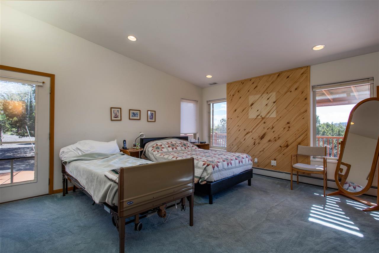18735 Northridge Road Cedaredge, CO 81413 - Photo 16 of 26 a bedroom with a bed and a window