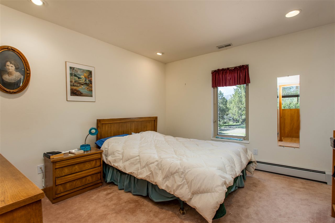 18735 Northridge Road Cedaredge, CO 81413 - Photo 19 of 26 a bedroom with a bed and a window