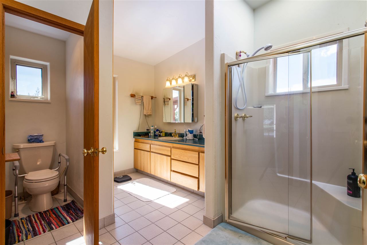 18735 Northridge Road Cedaredge, CO 81413 - Photo 21 of 26 a bathroom with a granite countertop sink toilet and shower