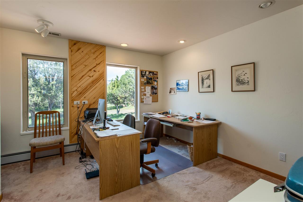 18735 Northridge Road Cedaredge, CO 81413 - Photo 23 of 26 a view of a workspace with furniture and a window