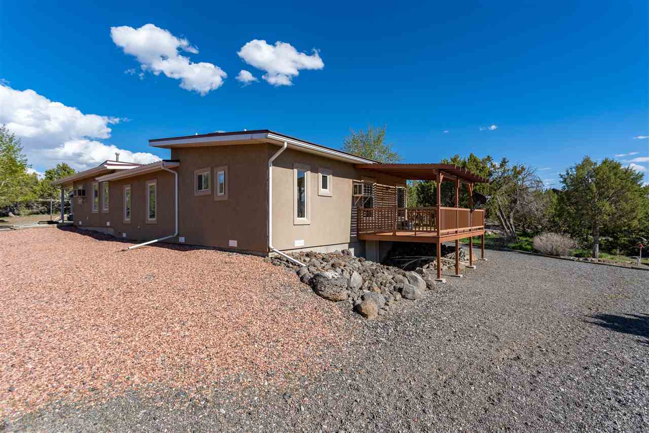 18735 Northridge Road Cedaredge, CO 81413 - Photo 4 of 26 a front view of a house with a yard and seating space