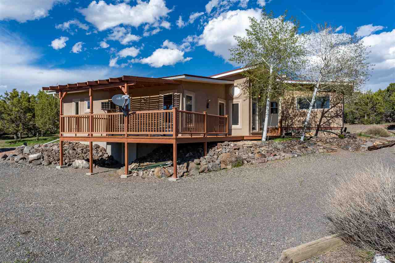 18735 Northridge Road Cedaredge, CO 81413 - Photo 6 of 26 a front view of a house with a yard balcony and seating space