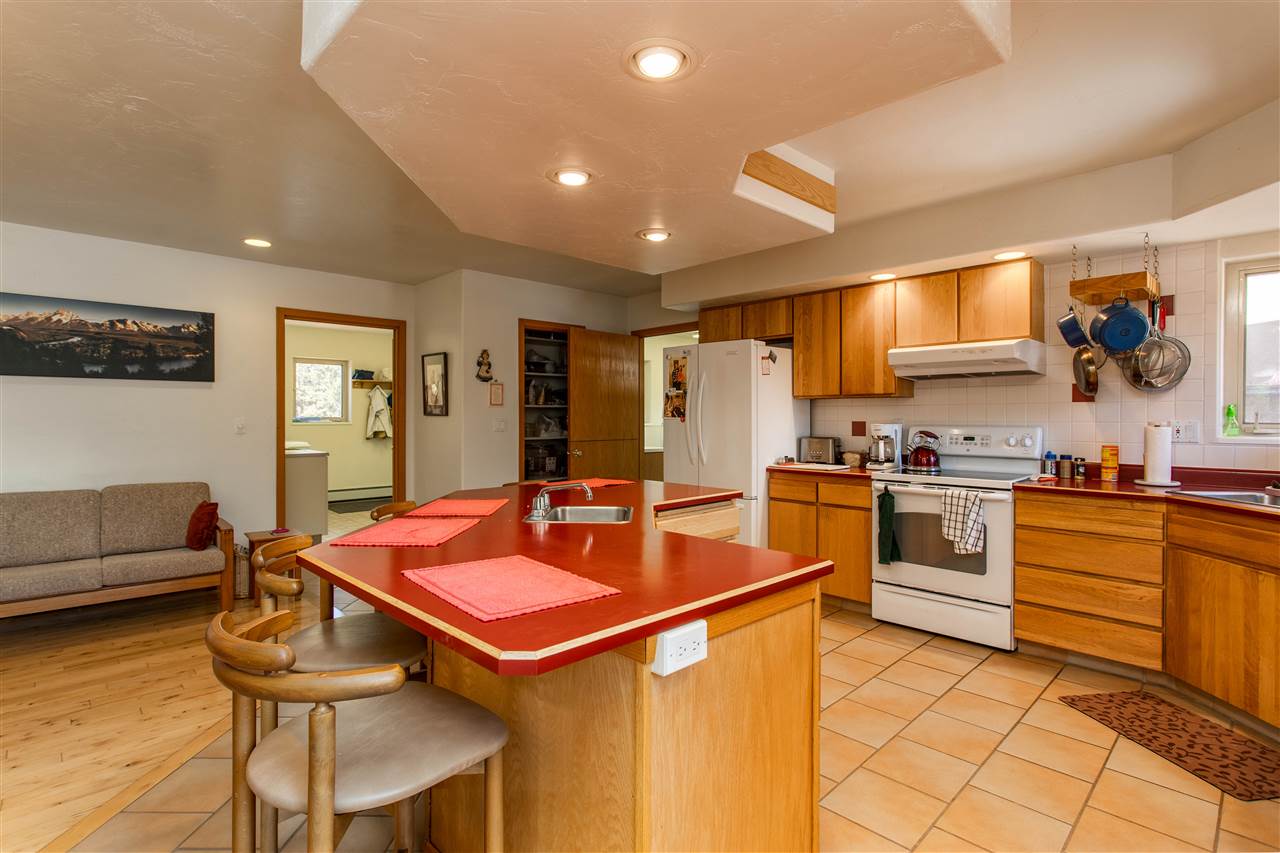 18735 Northridge Road Cedaredge, CO 81413 - Photo 9 of 26 a kitchen with stainless steel appliances kitchen island granite countertop a sink and chairs