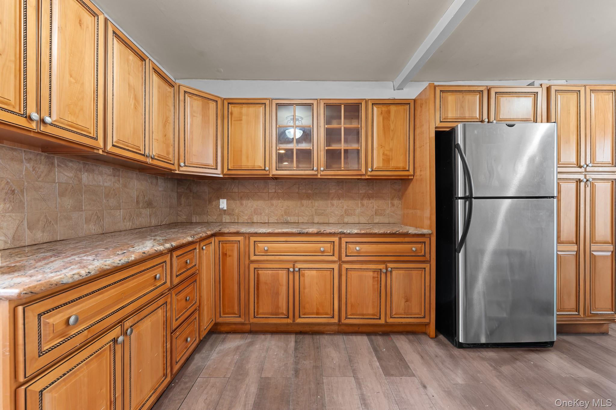 1638 East 45th Street Brooklyn, NY 11234 - Photo 3 of 16 a kitchen with stainless steel appliances granite countertop a refrigerator sink and cabinets