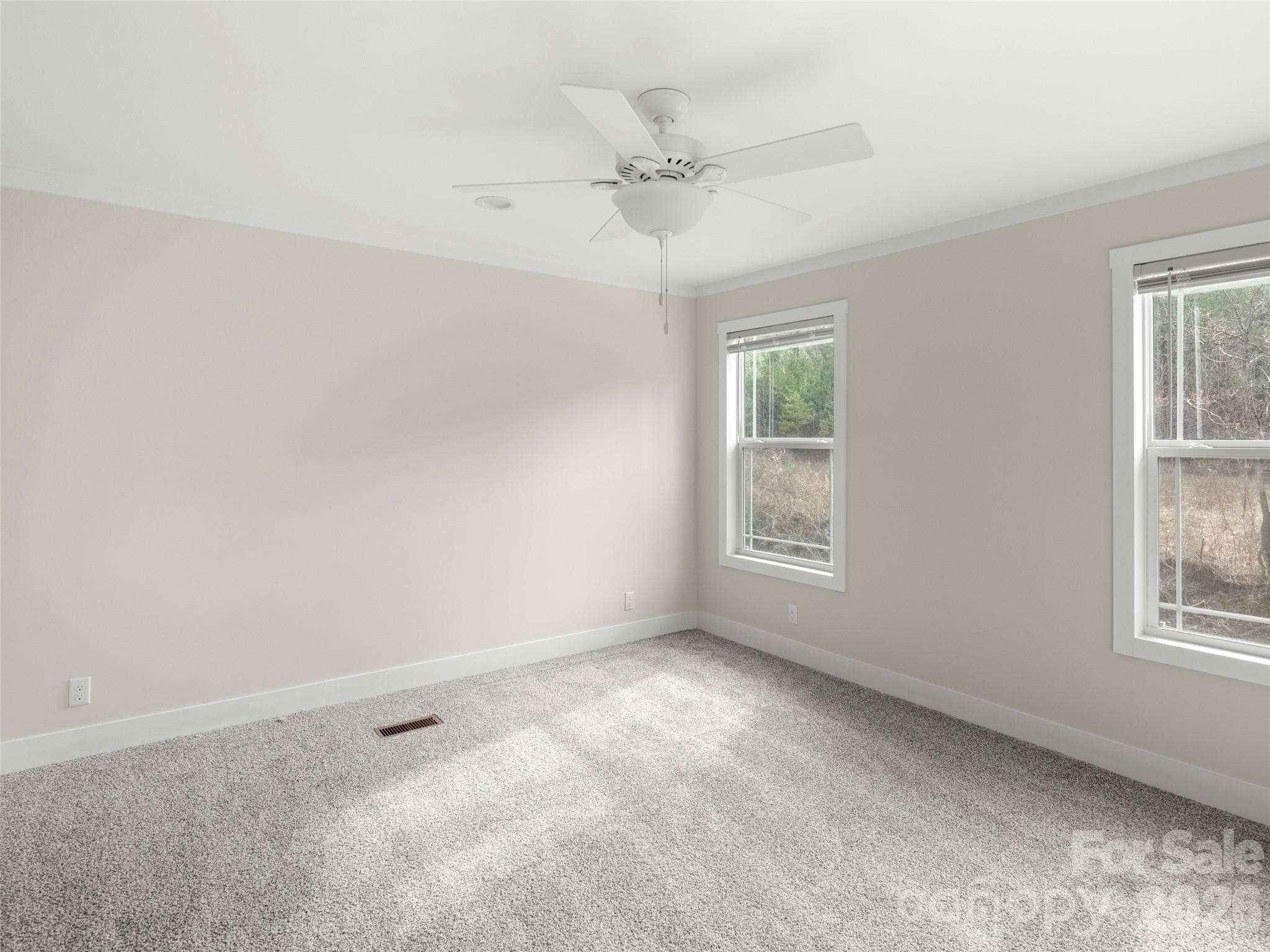 2095 Emmas Grove Road Fairview, NC 28730 - Photo 12 of 24 an empty room with windows and fan