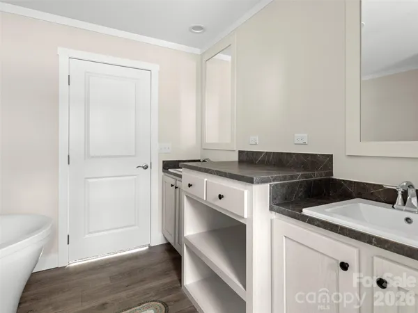 a utility room with granite countertop cabinets and sink