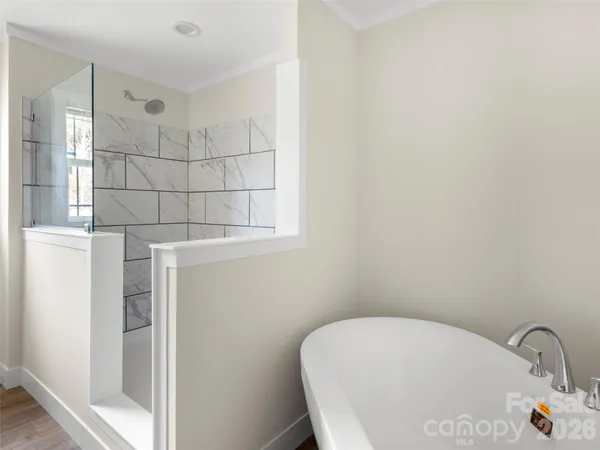 a bathroom with a bathtub and shower