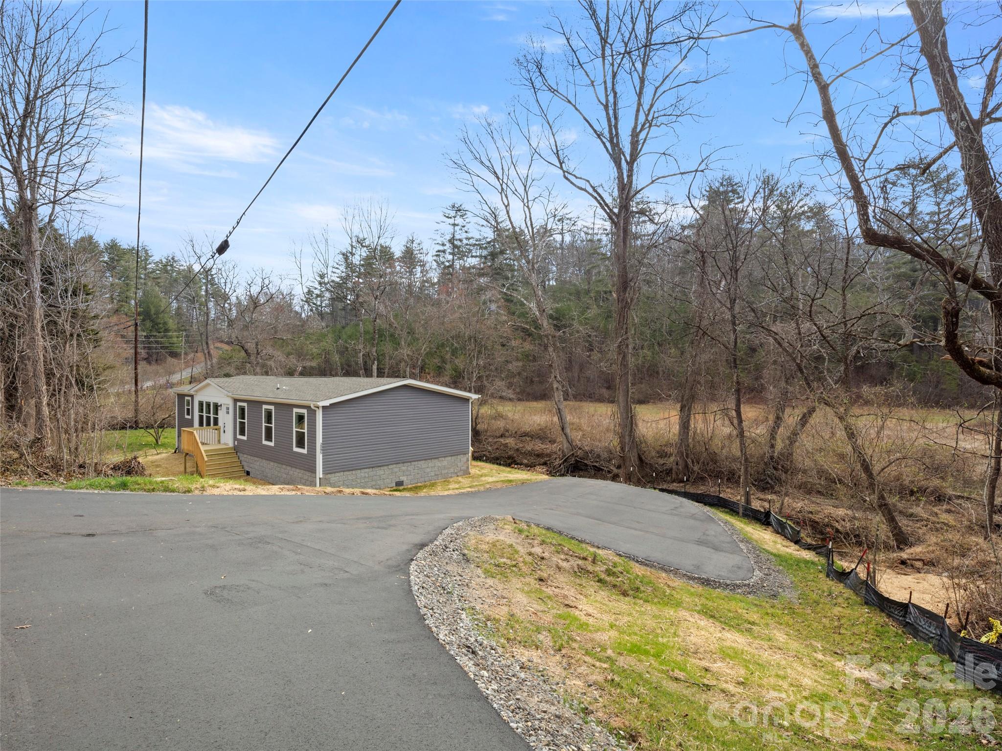 2095 Emmas Grove Road Fairview, NC 28730 - Photo 21 of 24 a view of a swimming pool with a yard