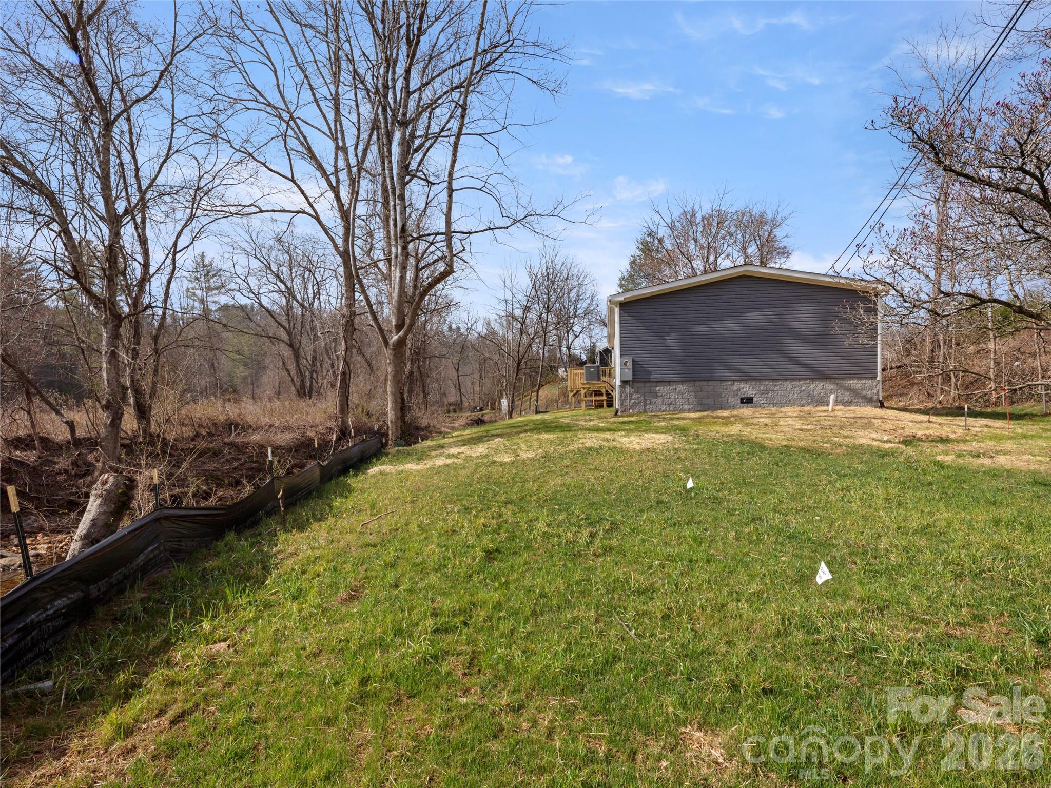 2095 Emmas Grove Road Fairview, NC 28730 - Photo 22 of 24 a view of a backyard with large trees