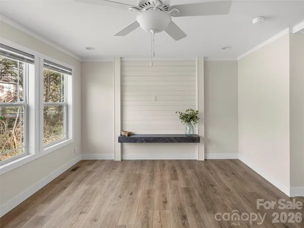 wooden floor in an empty room with a window