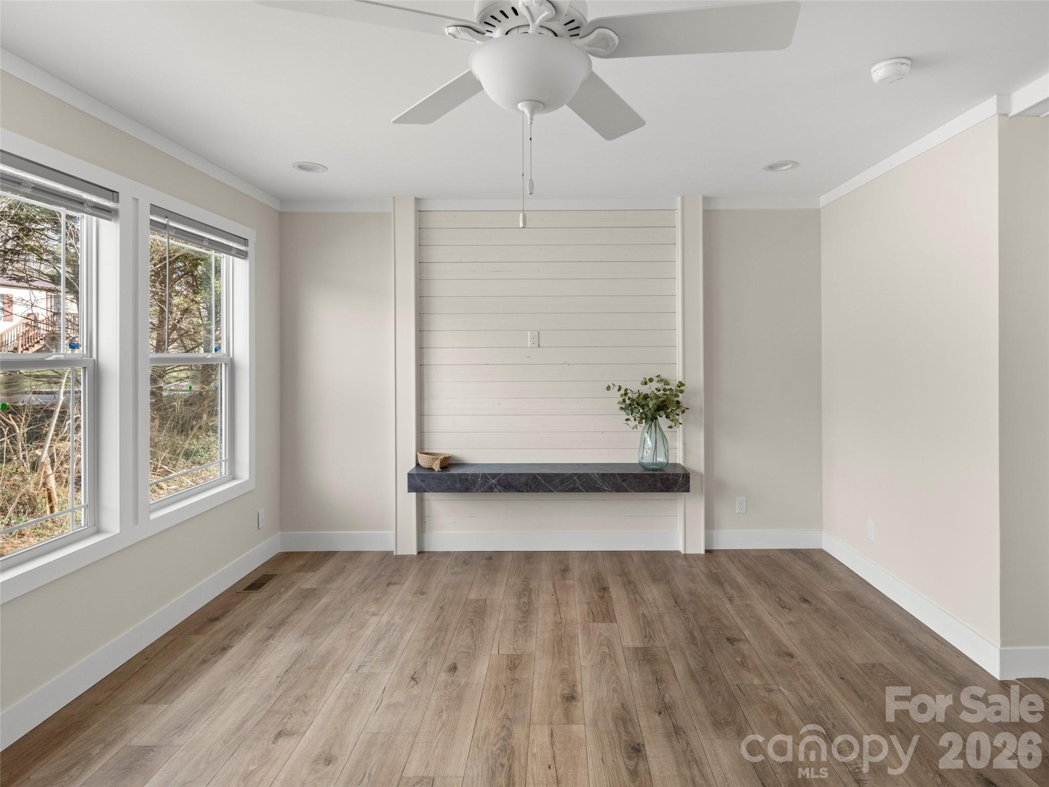 2095 Emmas Grove Road Fairview, NC 28730 - Photo 3 of 24 wooden floor in an empty room with a window