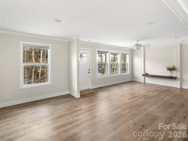 an empty room with windows and closet